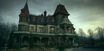 Movie still from “Locke & Key” (2020), created by Carlton Cuse – An old mansion with a car parked in front of it; Extreme Wide shot, Low angle