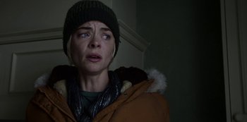 Movie still from “Black Summer” (2019), created by John Hyams – A woman in a brown jacket and a black hat; Close Up shot, Over the shoulder angle