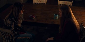 Movie still from “Locke & Key” (2020), created by Carlton Cuse – Two people sitting at a table with a cup of coffee; Medium shot, Over the shoulder angle