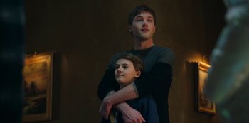 Movie still from “Locke & Key” (2020), created by Carlton Cuse – A man and a boy standing next to each other; Medium shot, Low angle