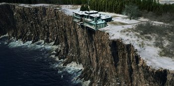 Movie still from “Locke & Key” (2020), created by Carlton Cuse – An aerial view of a house perched on a cliff edge; Extreme Wide shot, High angle