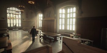 Movie still from “Locke & Key” (2020), created by Carlton Cuse – A man standing in front of a window in a room; Extreme Wide shot, High angle