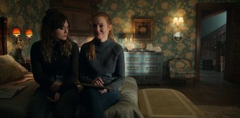 Movie still from “Locke & Key” (2020), created by Carlton Cuse – Two women sitting on a couch in front of a mirror; Medium shot, Over the shoulder angle
