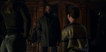 Movie still from “Locke & Key” (2020), created by Carlton Cuse – A man standing next to another man in a room; Medium shot, Over the shoulder angle