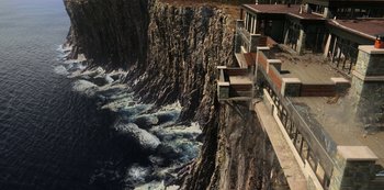 Movie still from “Locke & Key” (2020), created by Carlton Cuse – A view of a cliff with a house on the side of it; Extreme Wide shot, Overhead angle