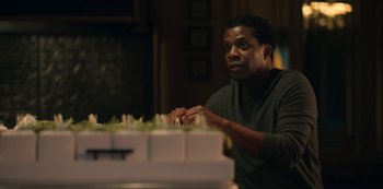 Movie still from “Locke & Key” (2020), created by Carlton Cuse – A man sitting in front of a bunch of candles; Medium shot, Over the shoulder angle