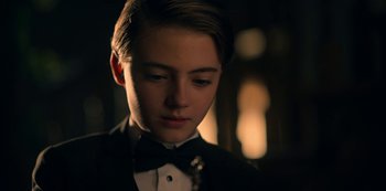 Movie still from “Locke & Key” (2020), created by Carlton Cuse – A young man in a black suit and bow tie; Close Up shot, Over the shoulder angle