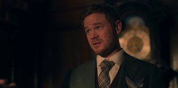 Movie still from “Locke & Key” (2020), created by Carlton Cuse – A person wearing a suit and a tie; Close Up shot, Over the shoulder angle