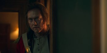 Movie still from “Locke & Key” (2020), created by Carlton Cuse – A man standing next to a door looking at the camera; Close Up shot, Over the shoulder angle