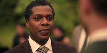 Movie still from “Locke & Key” (2020), created by Carlton Cuse – A person wearing a suit and tie; Close Up shot, Low angle