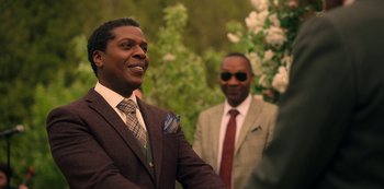 Movie still from “Locke & Key” (2020), created by Carlton Cuse – A man in a suit and tie standing next to another man in a suit and tie; Medium shot, Over the shoulder angle