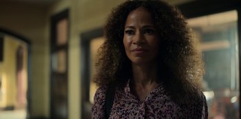 Movie still from “Locke & Key” (2020), created by Carlton Cuse – A person with curly hair wearing a dress; Close Up shot, Over the shoulder angle