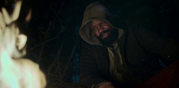 Movie still from “Black Summer” (2019), created by John Hyams – A man with a beard wearing a hooded jacket; Medium shot, Low angle