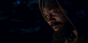 Movie still from “Black Summer” (2019), created by John Hyams – A man with a beard is looking at the camera; Close Up shot, Low angle