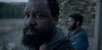 Movie still from “Black Summer” (2019), created by John Hyams – A man with a long beard and a man with a black beard; Close Up shot, Over the shoulder angle