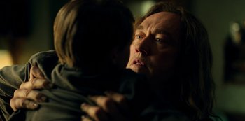 Movie still from “Locke & Key” (2020), created by Carlton Cuse – An older man holding a young child in his arms; Close Up shot, Over the shoulder angle