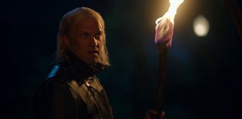 Movie still from “Locke & Key” (2020), created by Carlton Cuse – A man with long blonde hair holding a burning candle; Close Up shot, Over the shoulder angle