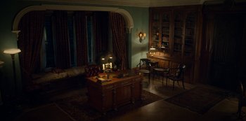 Movie still from “Locke & Key” (2020), created by Carlton Cuse – A living room filled with furniture next to a window; Wide shot, High angle