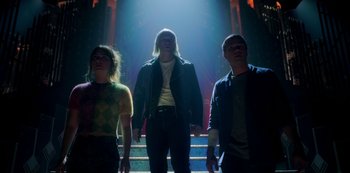 Movie still from “Locke & Key” (2020), created by Carlton Cuse – A group of people standing on steps in a dark room; Wide shot, Low angle