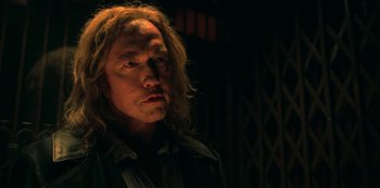 Movie still from “Locke & Key” (2020), created by Carlton Cuse – A man with long blonde hair is looking to his left; Close Up shot, Low angle