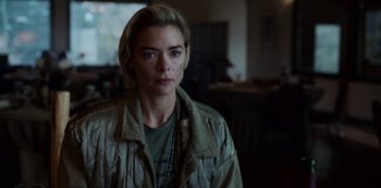 Movie still from “Black Summer” (2019), created by John Hyams – A woman in a green shirt is looking at the camera; Close Up shot, Over the shoulder angle