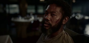 Movie still from “Black Summer” (2019), created by John Hyams – A person with a beard; Close Up shot, Low angle