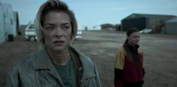 Movie still from “Black Summer” (2019), created by John Hyams – A woman standing next to another woman on a field; Close Up shot, Over the shoulder angle