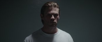 Movie still from “Blackhat” (2015), directed by Michael Mann – A person wearing a white t - shirt; Close Up shot, Low angle