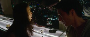 Movie still from “Blackhat” (2015), directed by Michael Mann – A man and a woman looking at each other in front of a martini glass; Close Up shot, Overhead angle