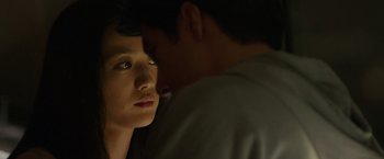 Movie still from “Blackhat” (2015), directed by Michael Mann – A young man and a young woman looking into each other's eyes; Close Up shot, Over the shoulder angle