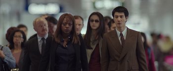 Movie still from “Blackhat” (2015), directed by Michael Mann – A group of people walking down a busy street; Medium shot, Over the shoulder angle