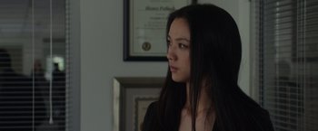 Movie still from “Blackhat” (2015), directed by Michael Mann – A woman with long black hair looking to her left; Close Up shot, Over the shoulder angle