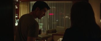 Movie still from “Blackhat” (2015), directed by Michael Mann – A man and a woman in a living room; Close Up shot, Over the shoulder angle