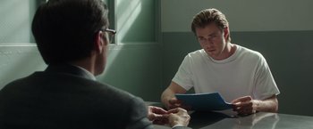 Movie still from “Blackhat” (2015), directed by Michael Mann – A man sitting in front of another man at a table; Medium shot, Over the shoulder angle