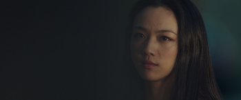 Movie still from “Blackhat” (2015), directed by Michael Mann – A young woman is looking at the camera; Close Up shot, Low angle