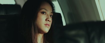 Movie still from “Blackhat” (2015), directed by Michael Mann – A woman sitting in the back seat of a car; Close Up shot, Low angle