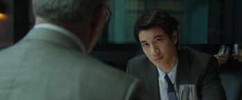 Movie still from “Blackhat” (2015), directed by Michael Mann – A man in a suit and tie talking to another man; Close Up shot, Over the shoulder angle