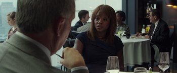 Movie still from “Blackhat” (2015), directed by Michael Mann – A woman sitting in front of a man at a table; Close Up shot, Over the shoulder angle