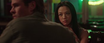 Movie still from “Blackhat” (2015), directed by Michael Mann – A woman sitting in front of a man in front of a mirror; Close Up shot, Over the shoulder angle