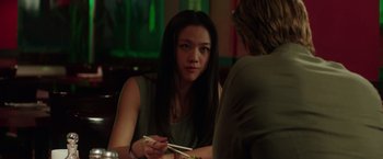 Movie still from “Blackhat” (2015), directed by Michael Mann – A woman sitting in front of a man holding chopsticks; Close Up shot, Over the shoulder angle