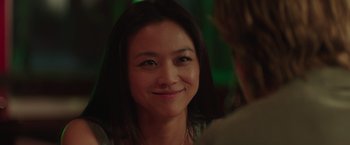 Movie still from “Blackhat” (2015), directed by Michael Mann – A person smiling at the camera; Close Up shot, Over the shoulder angle