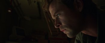 Movie still from “Blackhat” (2015), directed by Michael Mann – A person's face in the dark; Close Up shot, Low angle