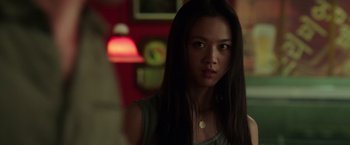 Movie still from “Blackhat” (2015), directed by Michael Mann – A woman with long black hair standing in front of a wall; Close Up shot, Over the shoulder angle