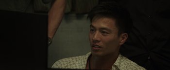 Movie still from “Blackhat” (2015), directed by Michael Mann – A man with a mustache and a beard; Close Up shot, Over the shoulder angle