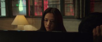 Movie still from “Blackhat” (2015), directed by Michael Mann – A woman sitting in front of a computer monitor; Close Up shot, Low angle