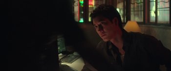 Movie still from “Blackhat” (2015), directed by Michael Mann – A man sitting in front of a computer at night; Close Up shot, Over the shoulder angle