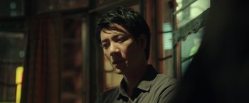 Movie still from “Blackhat” (2015), directed by Michael Mann – A person wearing a black shirt; Close Up shot, Over the shoulder angle