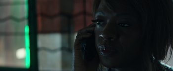 Movie still from “Blackhat” (2015), directed by Michael Mann – A person talking on a cell phone; Close Up shot, High angle