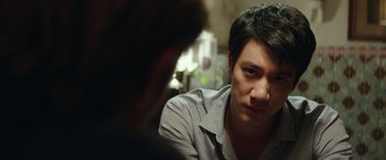 Movie still from “Blackhat” (2015), directed by Michael Mann – A man sitting in front of another man in a room; Close Up shot, Over the shoulder angle