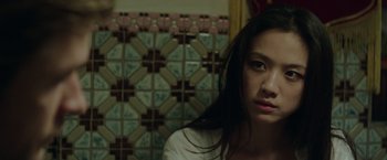 Movie still from “Blackhat” (2015), directed by Michael Mann – A woman with long black hair is looking at the camera; Close Up shot, High angle